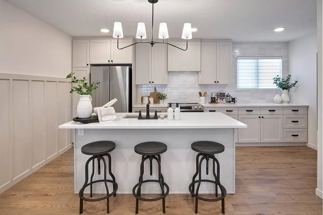 Kitchen with quartz island and stainless appliances